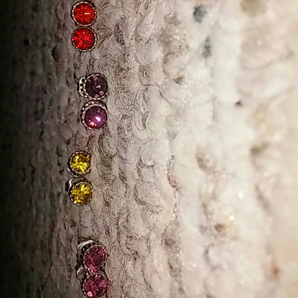 4 pairs of stud earrings with double backings.